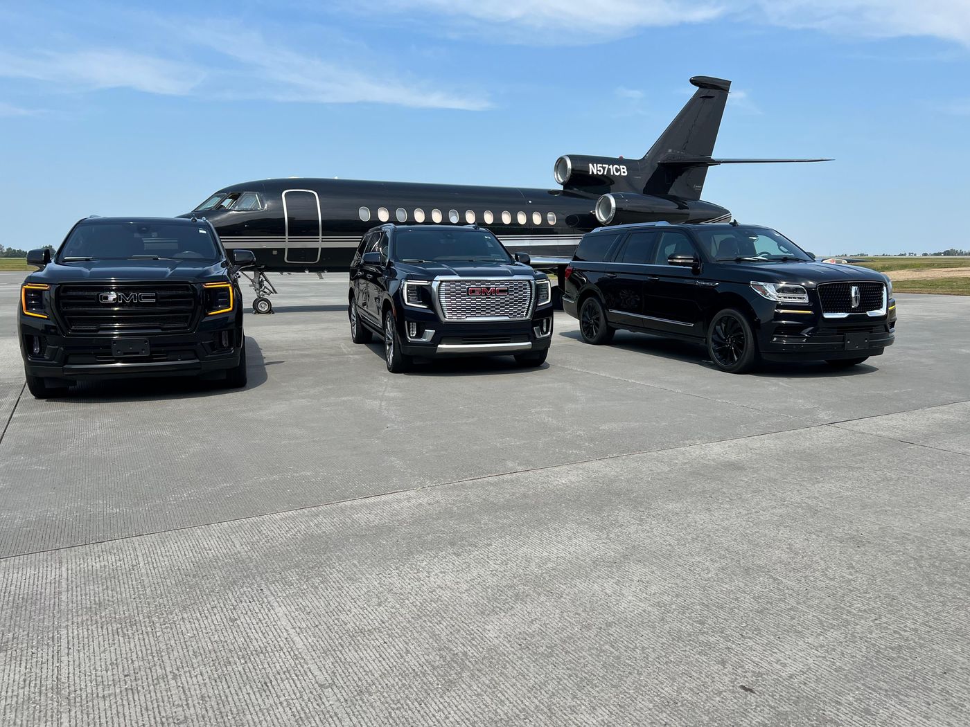 Ace Limousines' black executive SUVs beside a private jet on the tarmac.